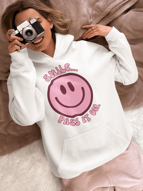 Introducing the ultimate mood booster in fabric form: the "Smile…Pass It On" Happy Face Hoodie! This isn't just any ordinary hoodie; it's a wearable ray of sunshine, guaranteed to spread joy, high-fives, and possibly even spontaneous dance-offs wherever you go.
